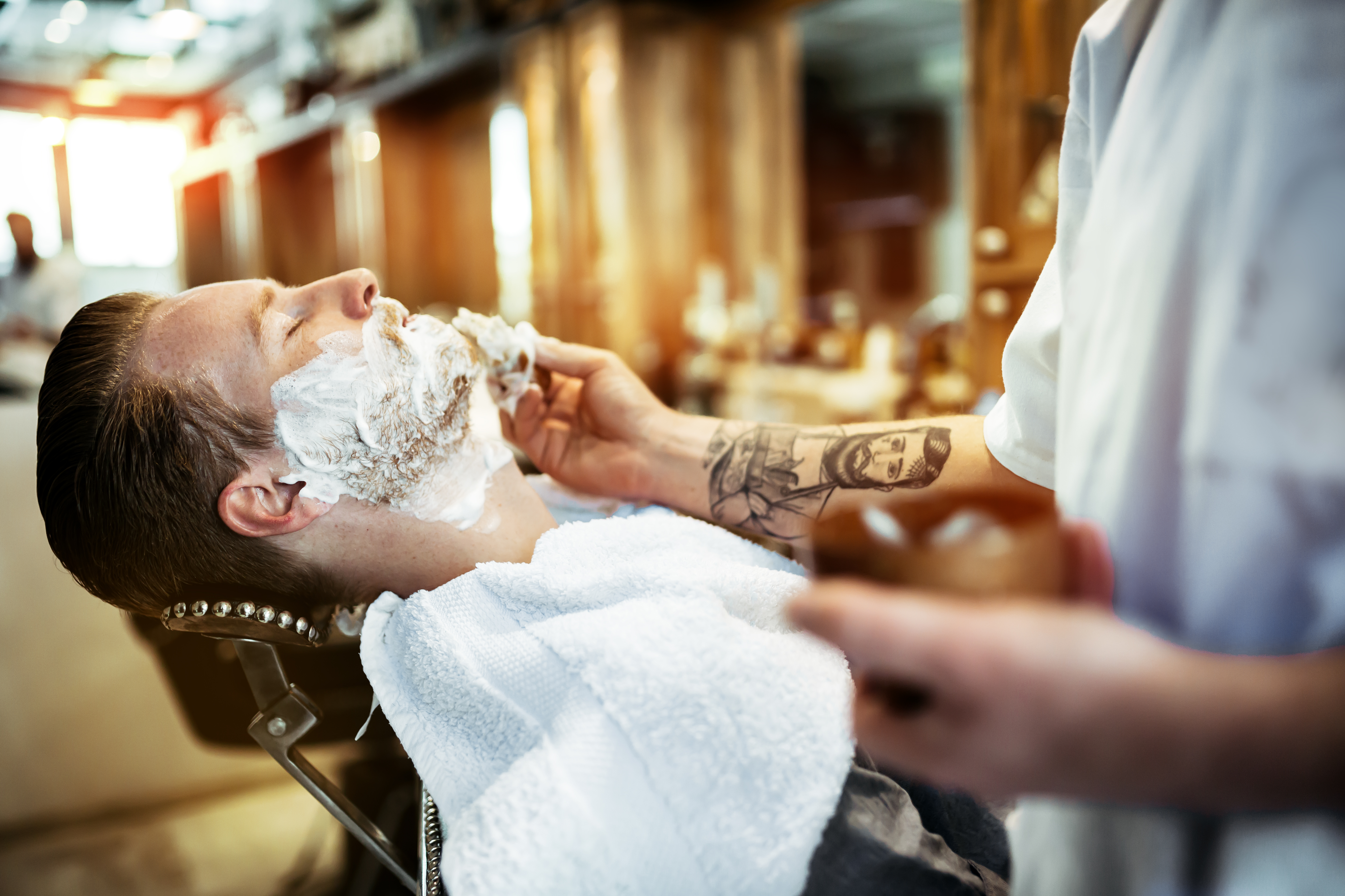 Retro shaving with foam in barber shop